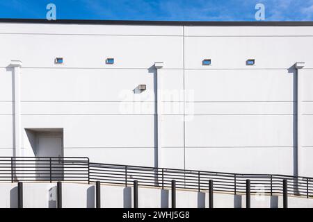 White wall, ramp, black railing and pylons Stock Photo