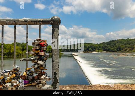 Love locks in front of the Savannah river rapids in Augusta in Georgia Stock Photo