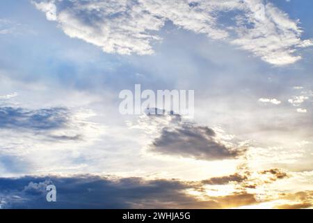 Sunset clouds with sun setting down. Beautiful evening sky with clouds background Stock Photo