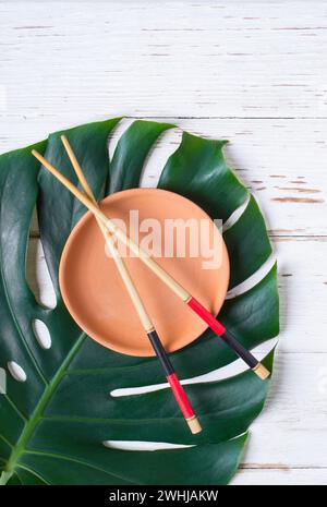 Chopstick and ceramic handmade dish. Asian food concept. Stock Photo
