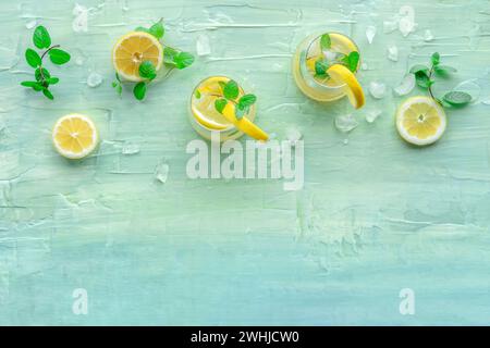 Lemonade with mint. Lemon water drink with ice. Two glasses and lemons Stock Photo
