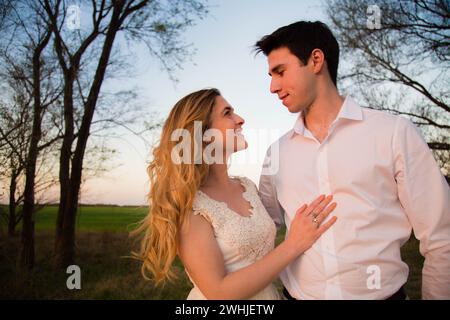 A young couple in an outdoor setting sharing an intimate moment. Cordoba, Argentina Stock Photo