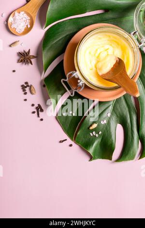 Ghee butter in a glass jar, pink salt and spices Stock Photo