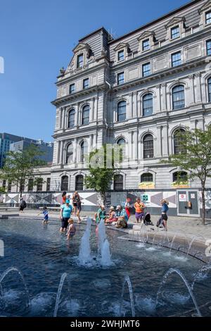 Montreal, Canada - aug 09 2023 - Children play in the waters of the Vauquelin fountain in downtown Montreal during the summer. Canada Stock Photo