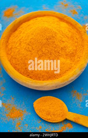 Ground turmeric on blue background Stock Photo