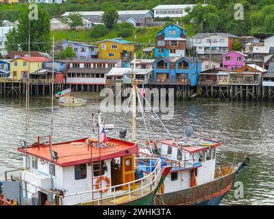 Houses built on stilts, known locally as Palafitos, lining the waters edge in Castro, capital of the Island of Chiloe in Chile Stock Photo