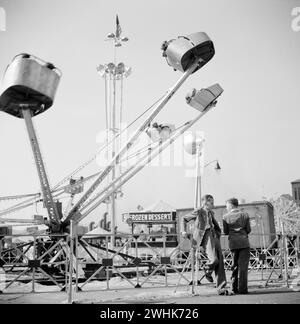 Two teen boys talking near carnival ride, Cotton Carnival, Memphis, Tennessee, USA, Marion Post Wolcott, U.S. Farm Security Administration, May 1940 Stock Photo