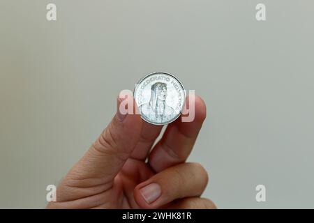 swiss five franc coin between fingers - swiss franc coin Stock Photo
