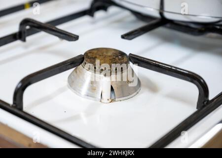 old rustic copper gas cooker on white background needs to be cleaned Stock Photo