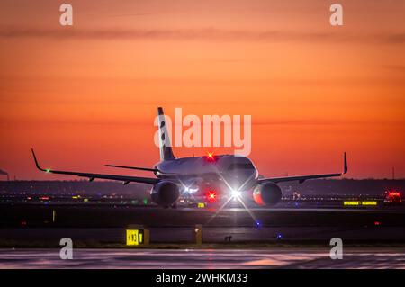 Early in the morning in front of sunrise at the airport, a Lufthansa aircraft stands ready for take-off on the runway, Fraport, Frankfurt am Main Stock Photo