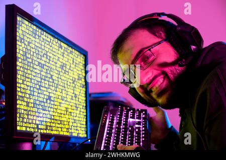 arabic guy working on some code trying to solve the problem Stock Photo