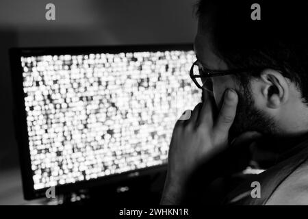 arabic guy working on some code trying to solve the problem Stock Photo