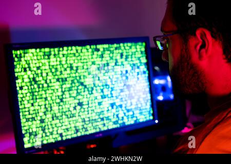 arabic guy working on some code trying to solve the problem Stock Photo