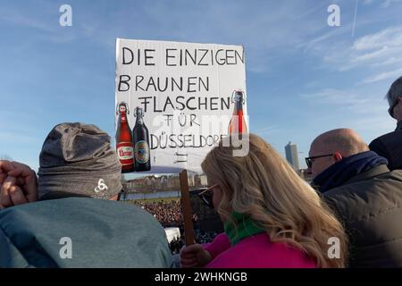 Demonstrators hold funny banner, Altbier bottles in the Nazi colour brown, large demonstration against right-wing extremism and AfD, on 27.1.2024 in Stock Photo
