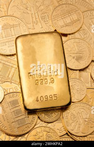 Investing in real gold with gold bars and gold coins Stock Photo