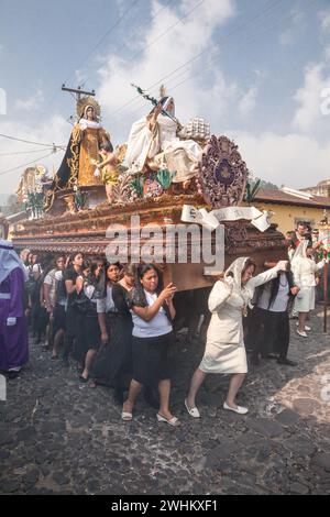 Antigua, Guatemala.  Semana Santa (Holy Week).  Women Carrying an Anda (Float) with the Virgin Mary in a Religious Procession. Stock Photo
