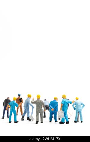 Miniature people , Worker team standing on white background, Labour day concept Stock Photo
