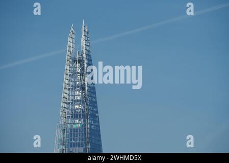 Sunlit Shard, the iconic skyscraper, stands against London's blue sky, UK. Stock Photo