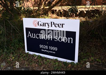 Gary Peer real estate agency sign, stating auction soon, sitting in a front garden outside a suburban Melbourne home Stock Photo