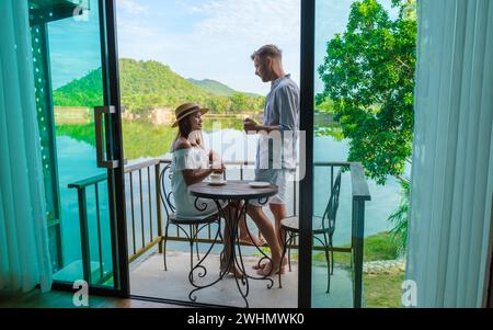 Couple on vacation in Thailand drinking coffee in the morning on their balcony Stock Photo