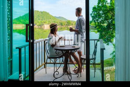 Couple on vacation in Thailand drinking coffee in the morning on their balcony Stock Photo