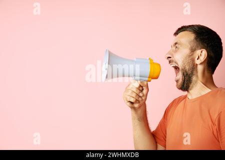 Funny man screaming in megaphone with copy space Stock Photo