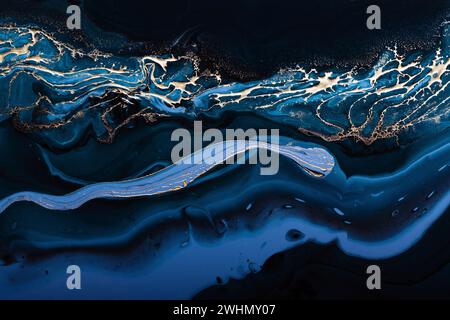 Fluid Art. Liquid Metallic Gold in abstract blue wave. Marble effect background or texture Stock Photo