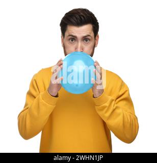 Man inflating light blue balloon on white background Stock Photo - Alamy