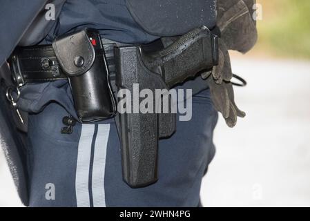 Police officer with service weapon Stock Photo