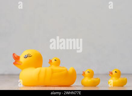 Yellow rubber ducks on a white background, children's toy Stock Photo