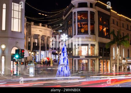 Beverly Hills, California, USA - November 17, 2021: Christmas Night time traffic streams through the heart of the Rodeo Drive shopping district. Stock Photo