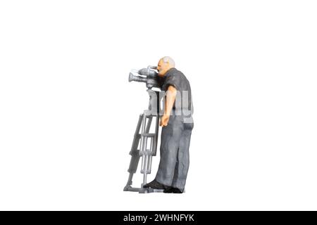 Cameraman working with television camera on a tripod isolated on white background with clipping path Stock Photo