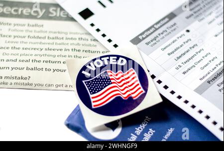 forms are filled in for the democratic party and ready to be returned, with a I voted sticker to assure me that my vote counts Stock Photo