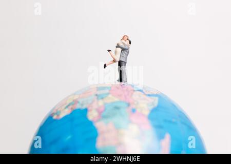 Miniature people figure  standing on the globe world map Stock Photo