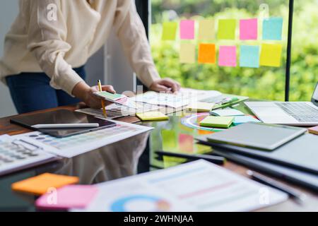 Creative idea Business female Artist Creative Designer sketch graphic drawing on graphic tablet and Color swatch samples Concept Stock Photo