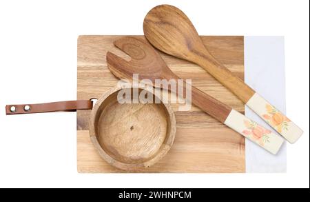 Wooden kitchen cutting board, spoons and an empty bowl on a white isolated background, top view Stock Photo
