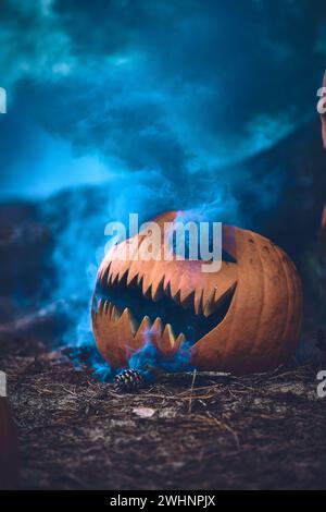 Halloween Pumpkin carved with smoke bomb Stock Photo
