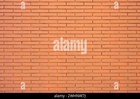 Background from a wall made of orange painted bricks Stock Photo