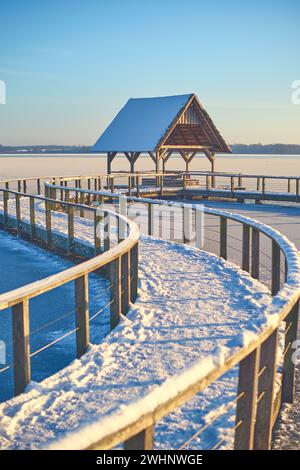 Curved footbridge over lake in northern Germany in Winter Stock Photo