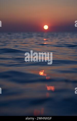 Setting sun reflecting in north sea water Stock Photo