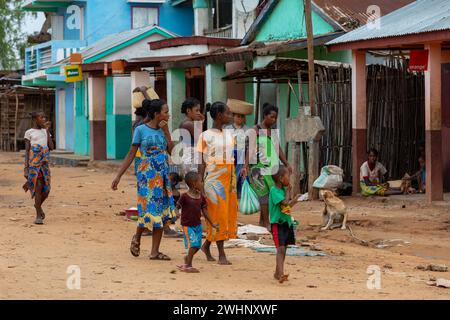 Malagasy woman's with children walking down the street. Bekopaka, Madagascar Stock Photo