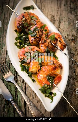 Tasty fresh shrimp skewers on plate Stock Photo