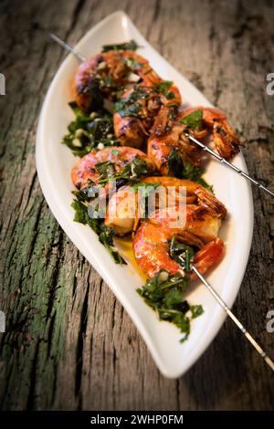 Tasty fresh shrimp skewers on plate Stock Photo