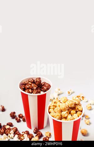 Assorted popcorn set in paper striped white red cup. Caramel and chocolate popcorn Stock Photo