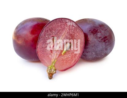 Front view of fresh red grapes with half in stack is isolated on white background with clipping path. Stock Photo