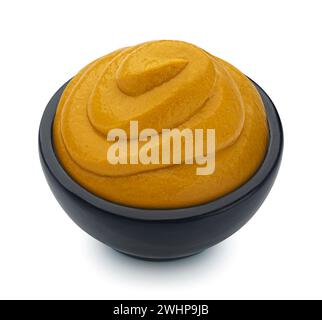 Mustard in black bowl isolated on white background, full depth of field Stock Photo