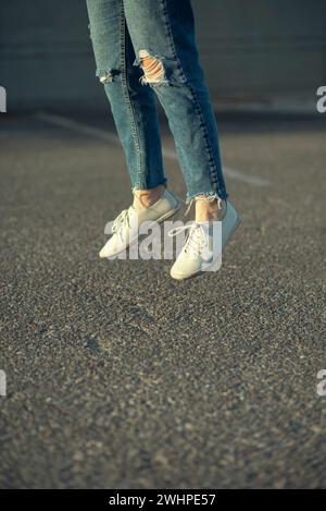 Close up of woman's legs jumping Stock Photo