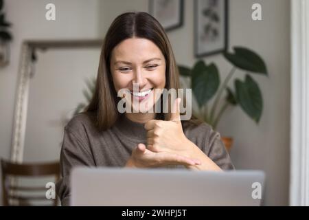 Cheerful hearing disability therapist talking on video conference call Stock Photo