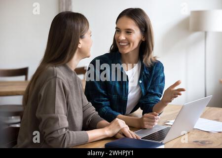 Two cheerful entrepreneurs discussing creative ideas for business project Stock Photo