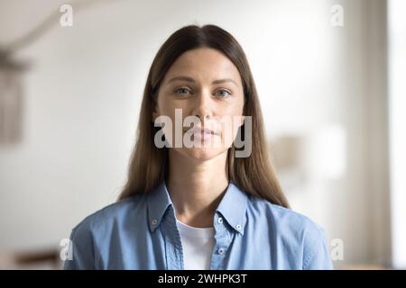 Positive young Caucasian woman with natural makeup looking at camera Stock Photo
